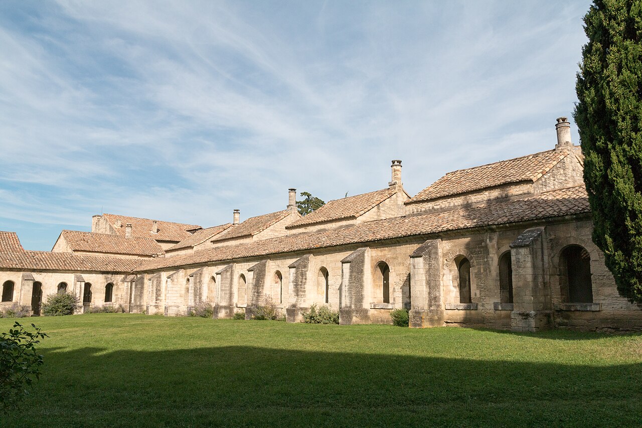 Le grand cloître de la chartreuse du Val de Bénédiction à Villeneuve-lès-Avignon, ses cellules de moines en pierre et leurs toits de tuiles autour d’une pelouse